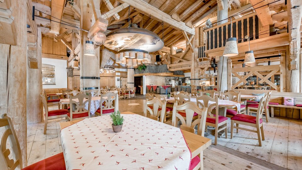 A rustic restaurant with wooden decor and cozy tables. The warm colors and inviting atmosphere create a pleasant place to eat.