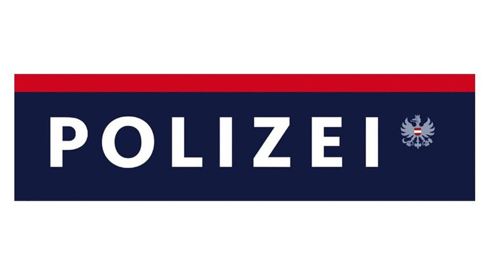 A logo of the police in blue, red, and white. The word "POLICE" is written in capital letters on it.