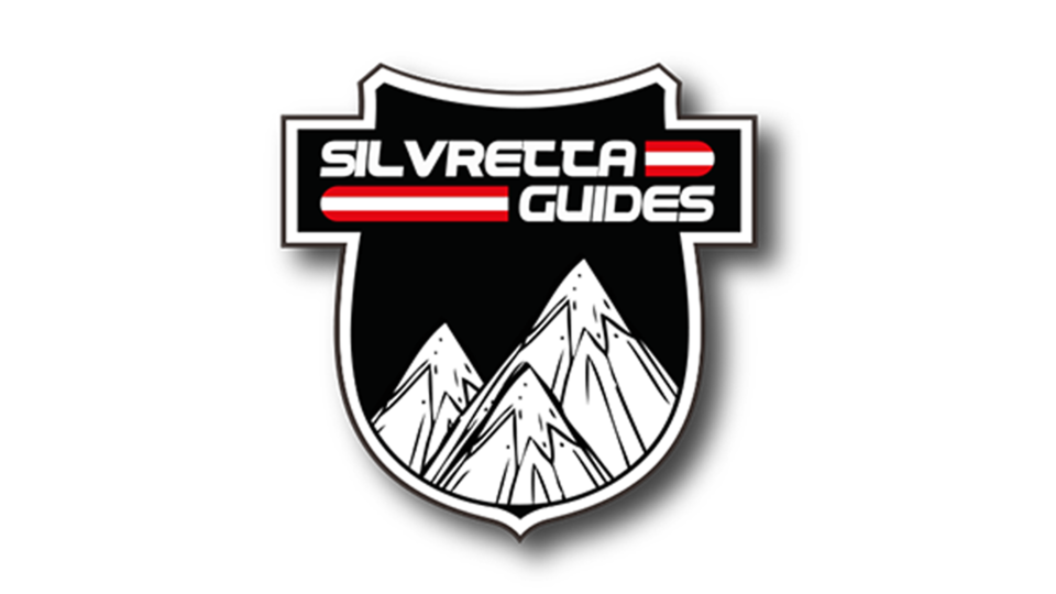 Ein Logo mit dem Namen "Silvretta Guides". Es zeigt stilisierte Berge auf einem schwarzen Schild.