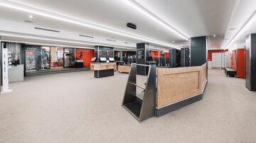 A modern and bright store with an open space. The walls are painted in neutral colors, and there are various areas for shopping.