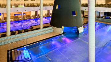 A modern swimming pool with stylish design and colorful lights. The area is inviting with loungers and a serene atmosphere.