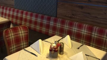 Ein gemütliches Restaurant mit rot karierten Bänken und elegant eingedeckten Tischen. Eine stilvolle Lampe hängt über einem der Tische.