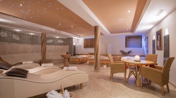 An elegant wellness area with comfortable loungers and a relaxing atmosphere. Soft lighting and stylish decor invite you to unwind.