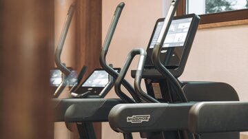 Modern training equipment in a fitness room. The room has large windows and offers a pleasant atmosphere for exercising.