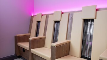 A modern relaxation area with comfortable armchairs. Soft lighting creates a calming atmosphere.